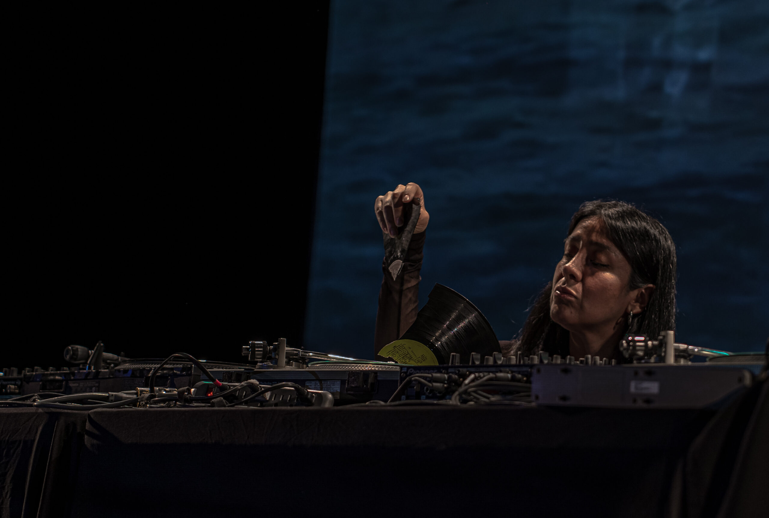 Maria behind turntables on stage